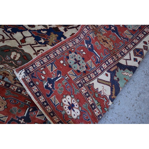 457 - A large rug, possibly Afghan, the cream central ground decorated with repeated geometric motif, link... 