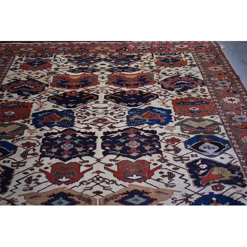 457 - A large rug, possibly Afghan, the cream central ground decorated with repeated geometric motif, link... 