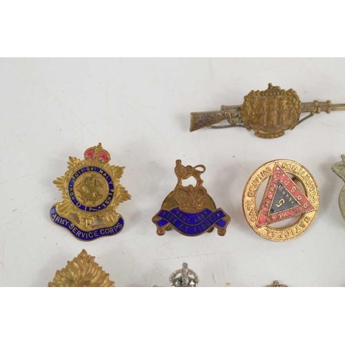 48 - A group of badges and brooches to include a Essex Regiment sweetheart brooch, Green Howards (Alexand... 