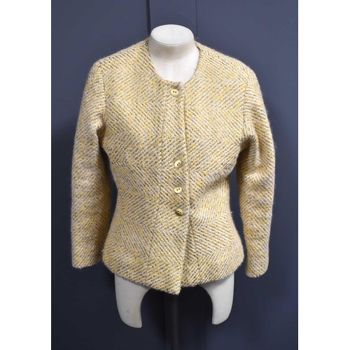 488 - A Chanel wool jacket, of classic form the cream ground with gold chevrons, and having cream silk lin... 