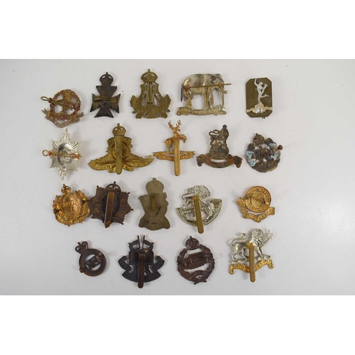 49 - A group of military cap badges to include Herefordshire Regiment, Irish Rifles, 19th Hussars, Royal ... 