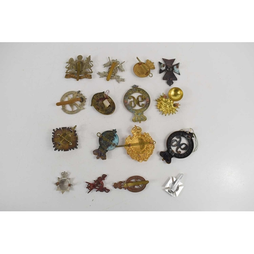 51 - A collection of military cap badges to include Manchester Regiment, Scots Guards officers forage cap... 