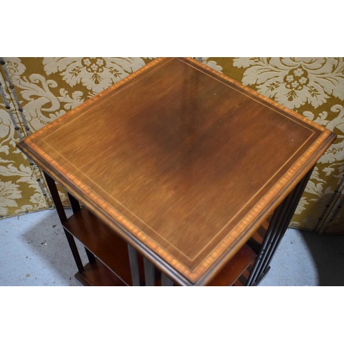 516 - An Edwardian mahogany revolving bookcase, the top with satin wood inlaid border.