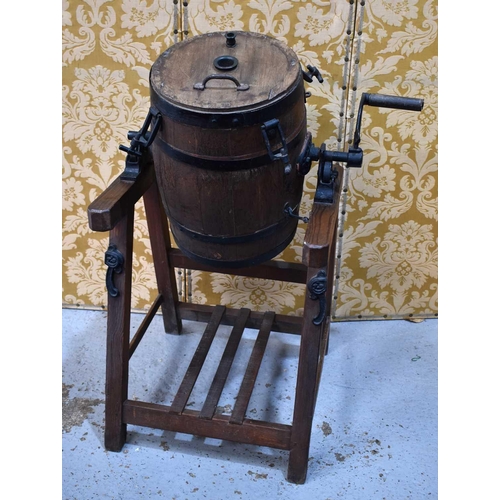 525 - A Braeford Patent revolving butter churn on stand, the coopered barrel having casto iron mounts and ... 