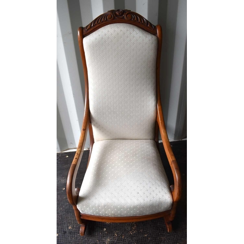 526 - A Victorian mahogany framed rocking chair, carved back, with cream upholstery.