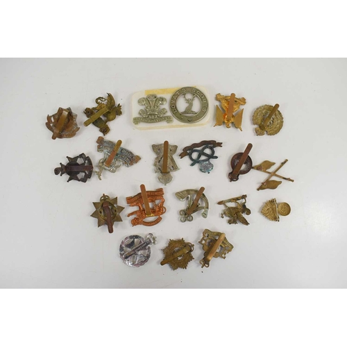 53 - A collection of military cap badges to include Devonshire Regiment, Lovat's Scouts, Earl of Chester'... 