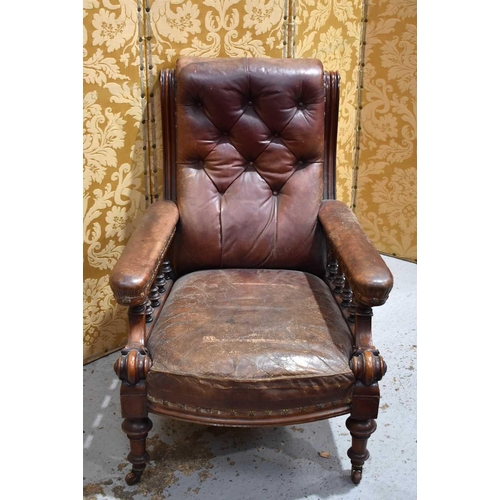 530 - A Victorian library arm chair, with scrolled button back and part upholstered arms, in dark red leat... 