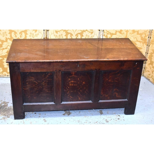 538 - An 18th century oak coffer with three panel front, the interior having a candle box, raised on stile... 