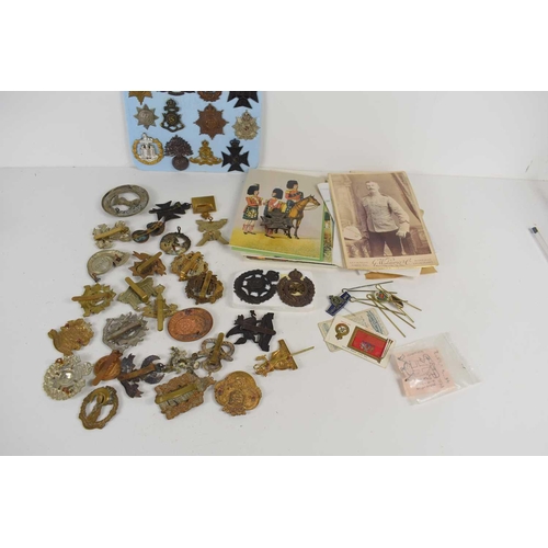 54 - A group of military cap badges including The Border Regiment, The Cambridgeshire Regiment, The Essex... 