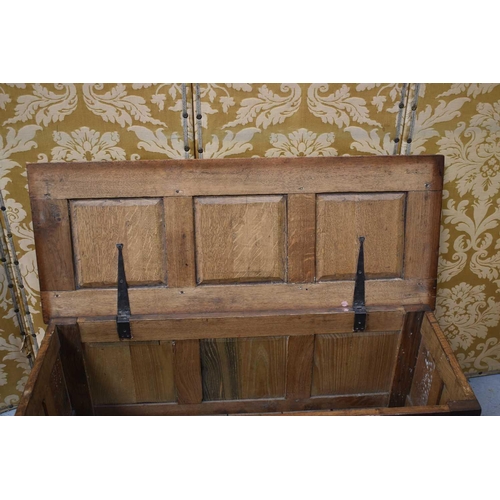 541 - A late 17th / early 18th century oak coffer, carved three panel front having surrounded by rosettes ... 