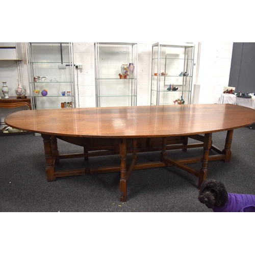 549 - A large oak drop leaf table in the refectory style, 336cm by 200cm.