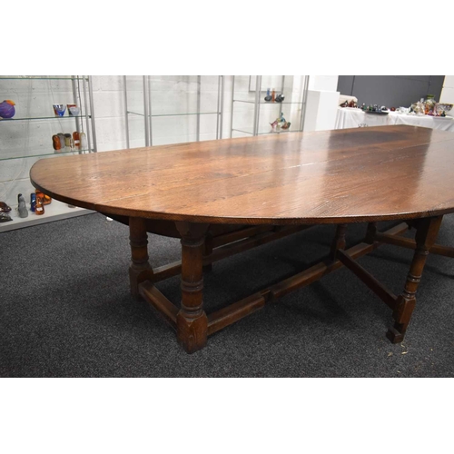 549 - A large oak drop leaf table in the refectory style, 336cm by 200cm.