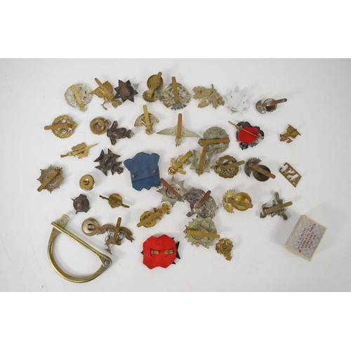 55 - A group of military cap badges including The Royal Electrical and Mechanical Engineers, Royal Welsh ... 