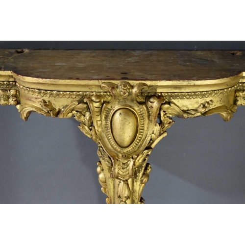 551 - A 19th century giltwood console table, with white marble top, the carved and gilded base having one ... 