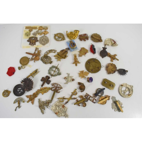 56 - A group of military cap badges including Army Educational Corps, Queen Mary's Army Auxiliary Corps, ... 