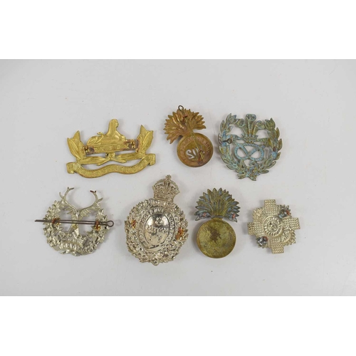 72 - A group of Victorian and later cap and pouch badges to include Gordon Highlanders, 64th Foot Staffor... 