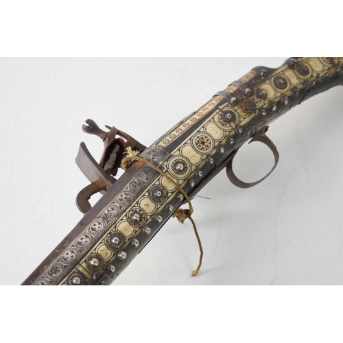 81 - A 19th century Ottoman flintlock long bore rifle, Black Bess rifle action, having bone inlaid decora... 