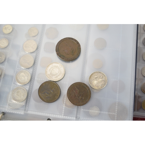 100a - Three coin albums containing GB and worldwide coins, some silver, to include a George III 1797 cartw... 