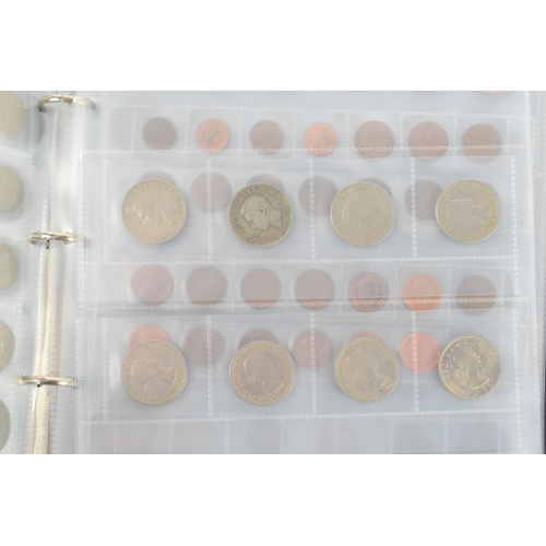 100a - Three coin albums containing GB and worldwide coins, some silver, to include a George III 1797 cartw... 