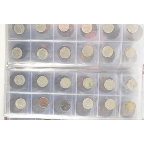 100a - Three coin albums containing GB and worldwide coins, some silver, to include a George III 1797 cartw... 