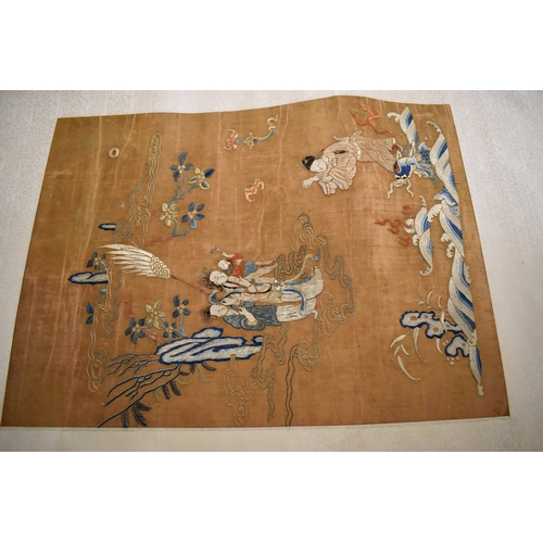 492 - A Chinese scroll with silk embroidered panel depicting two women holding a baby, with gentleman gest... 