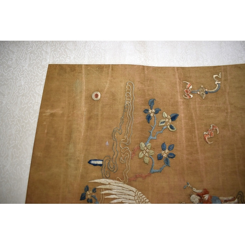 492 - A Chinese scroll with silk embroidered panel depicting two women holding a baby, with gentleman gest... 