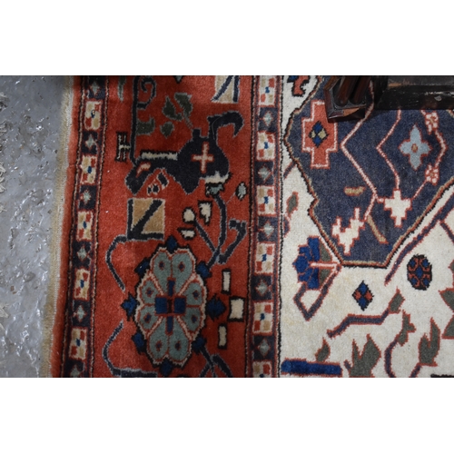 457 - A large rug, possibly Afghan, the cream central ground decorated with repeated geometric motif, link... 