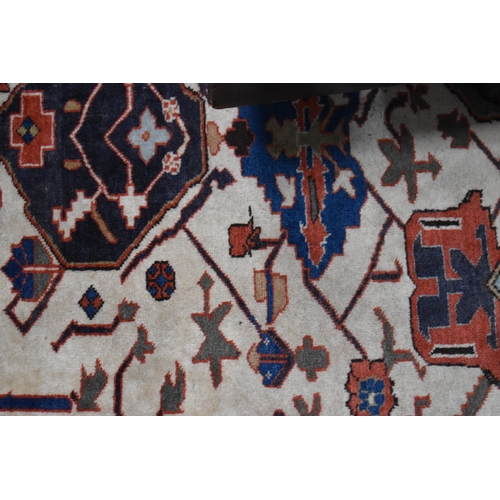 457 - A large rug, possibly Afghan, the cream central ground decorated with repeated geometric motif, link... 