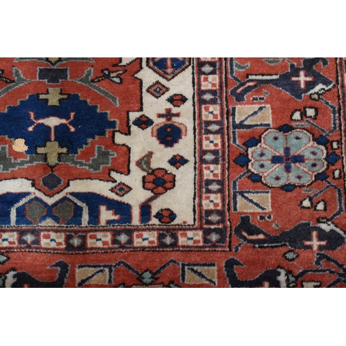 457 - A large rug, possibly Afghan, the cream central ground decorated with repeated geometric motif, link... 