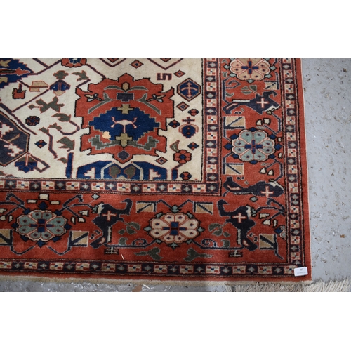 457 - A large rug, possibly Afghan, the cream central ground decorated with repeated geometric motif, link... 