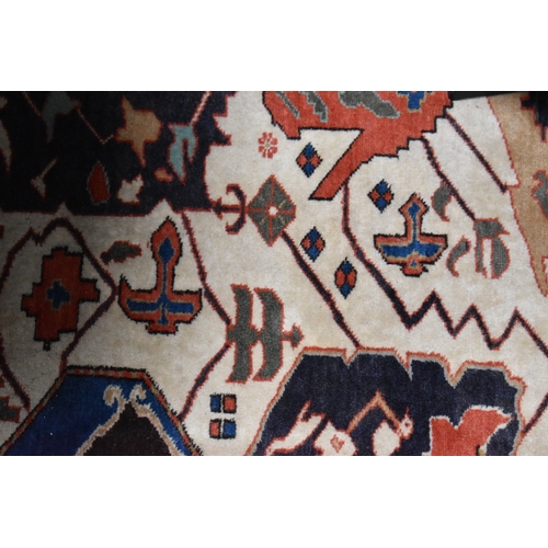 457 - A large rug, possibly Afghan, the cream central ground decorated with repeated geometric motif, link... 