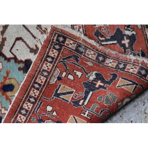 457 - A large rug, possibly Afghan, the cream central ground decorated with repeated geometric motif, link... 