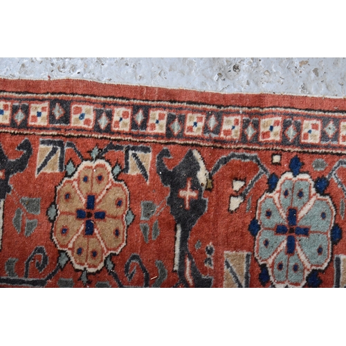 457 - A large rug, possibly Afghan, the cream central ground decorated with repeated geometric motif, link... 