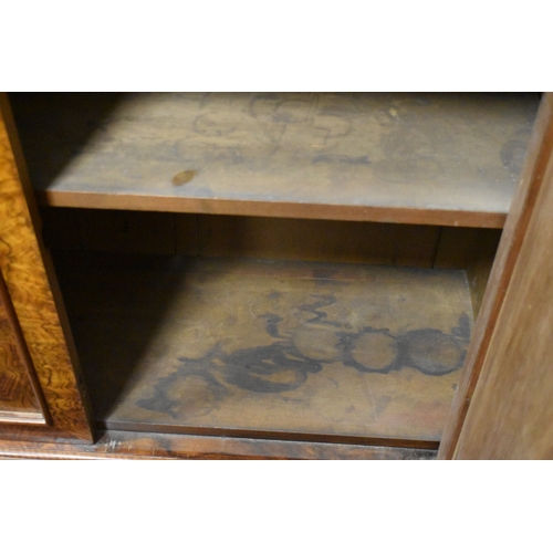 536 - A Victorian burr walnut chiffonier sideboard having two drawers above two cupboard doors, 93cms tall... 