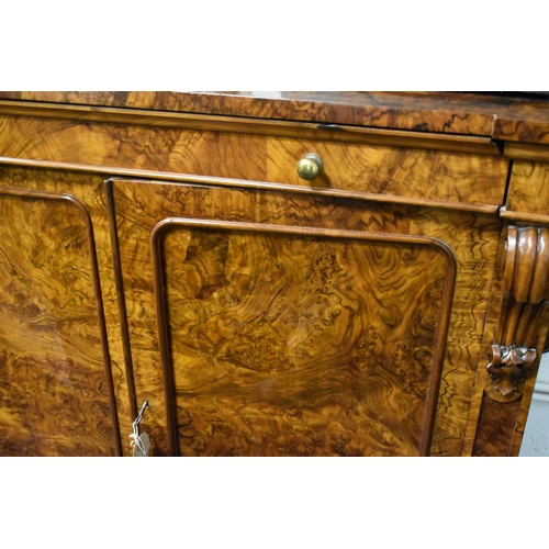 536 - A Victorian burr walnut chiffonier sideboard having two drawers above two cupboard doors, 93cms tall... 