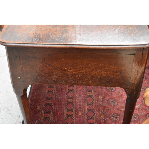 534 - A 17th century oak lowboy, with three short drawers to the front, raised on tapered legs with pad fe... 