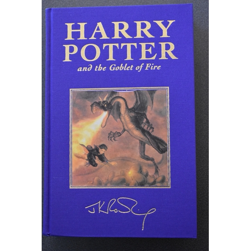 371 - A set of Harry Potter Deluxe edition books, the first five volumes bound in coloured fabric and enca... 