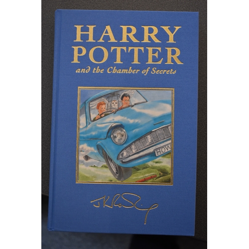 371 - A set of Harry Potter Deluxe edition books, the first five volumes bound in coloured fabric and enca... 