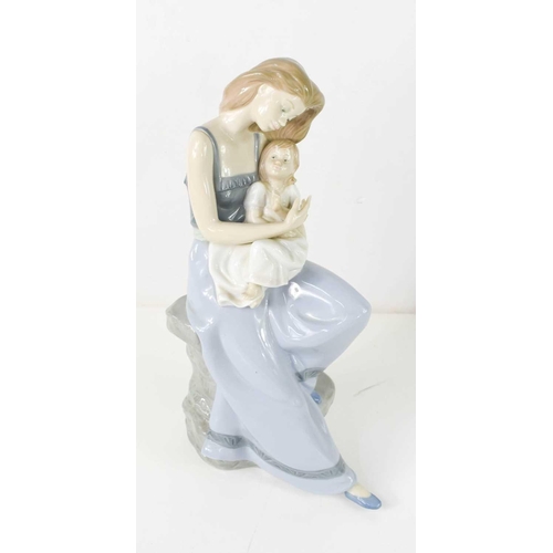 186 - A group of ten Nao figurines, including a large figure group of a mother and daughter, 38cm high, a ... 