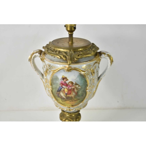 199 - A 19th century French Sevres style porcelain and gilt metal table lamp, the body having twin handles... 