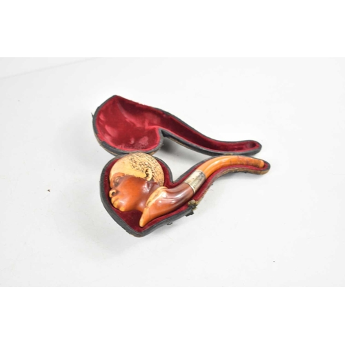 202 - A 19th century Meerschaum smoking pipe with silver collar, the bowl in the form of an African Americ... 