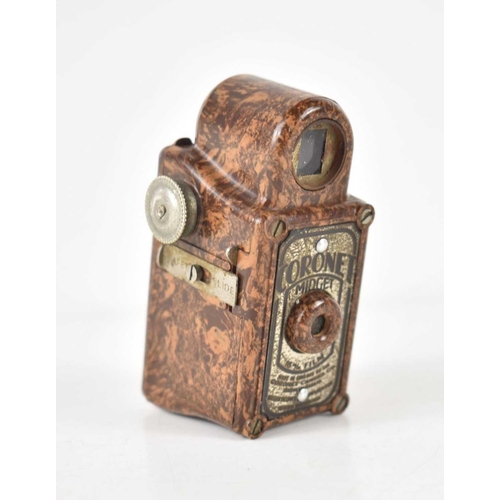 242 - A vintage Coronet Midget box camera, the camera having a brown mottled bakelite case, 6.5cm high.