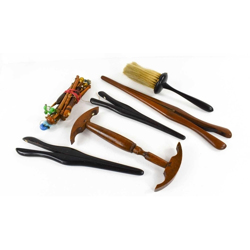 292 - A selection of 19th century treen, to include a fruitwood hat gauge, three pairs of glove stretchers... 