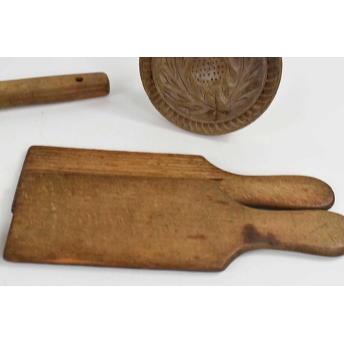 293 - A group of Victorian pine butter hand, two pairs of butter pats and a shortbread press.