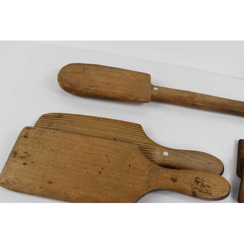 293 - A group of Victorian pine butter hand, two pairs of butter pats and a shortbread press.