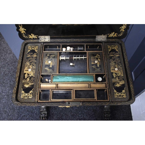 312 - A 19th century Chinoiserie black lacquered sewing table, decorated all over with figural scenes, and... 