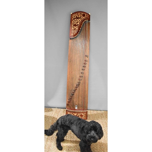 313 - A Chinese Guzheng or zither, made in the traditional form, with hard wood base, fretwork compartment... 