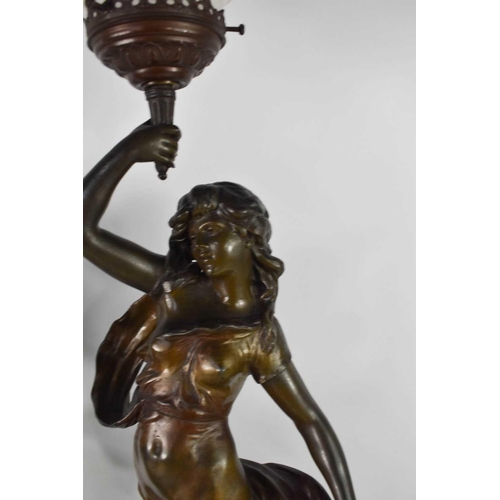 424 - After Auguste Moreau a pair of bronzed spelter figural lights, with flame form frosted glass shades,... 