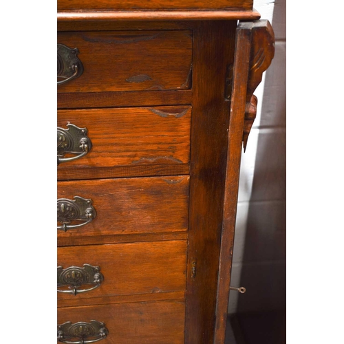 456 - An early 20th century oak Wellington type chest, the seven graduated drawers having Art Nouveau hand... 