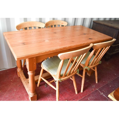 473 - A pine kitchen table 75 by 152 by 77cm high and four chairs.